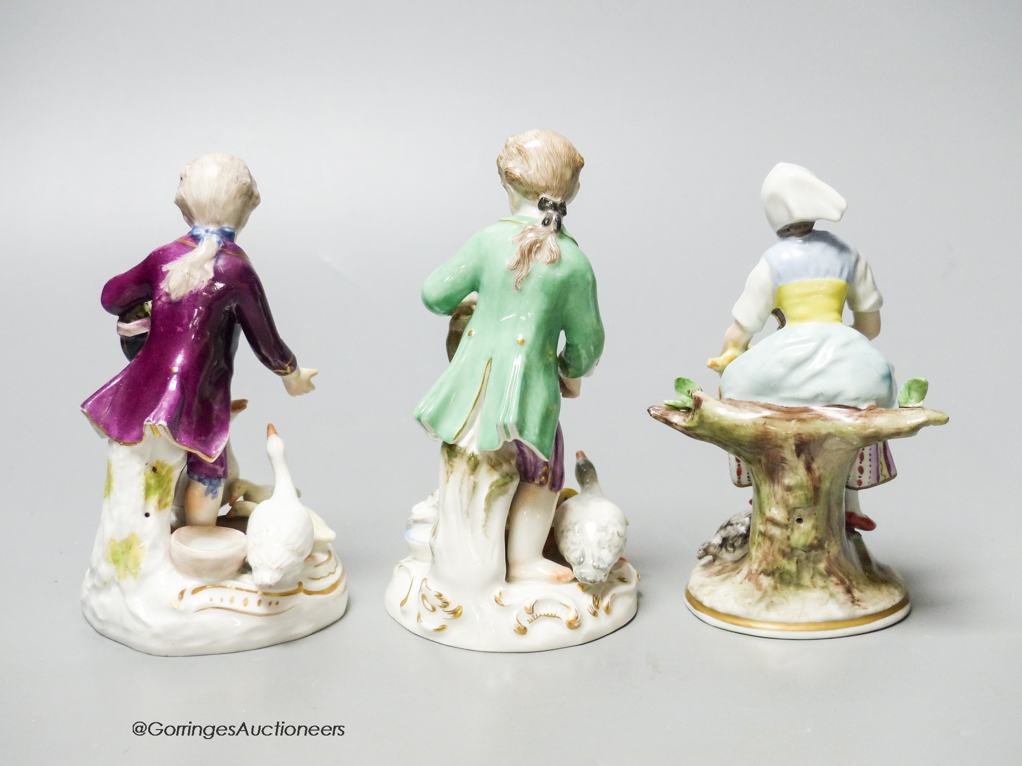 A Meissen porcelain group of a boy and ducks together with two Continental porcelain figures, tallest 12cm